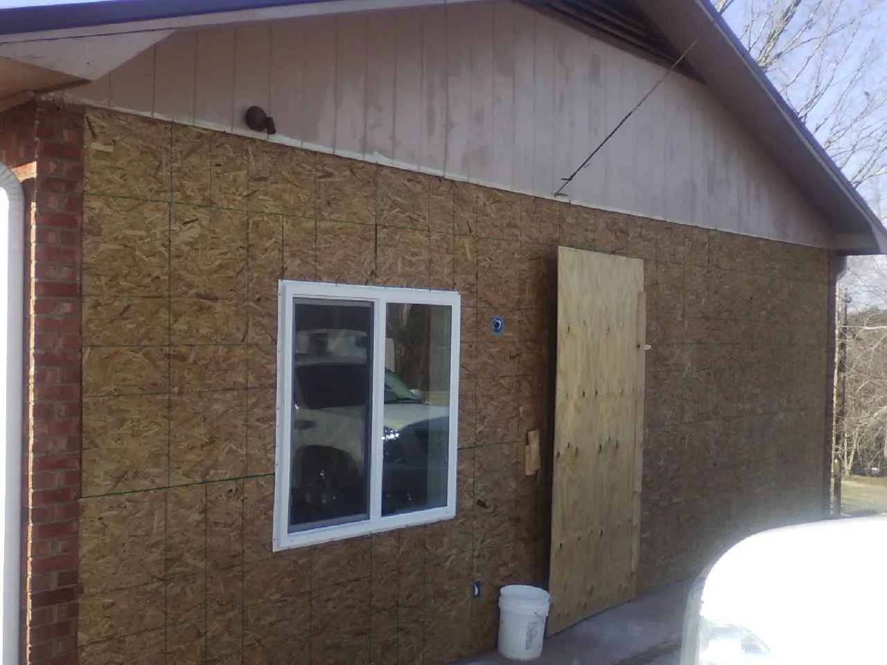 OSB sheathing on a garage addition wall before siding in Brecksville