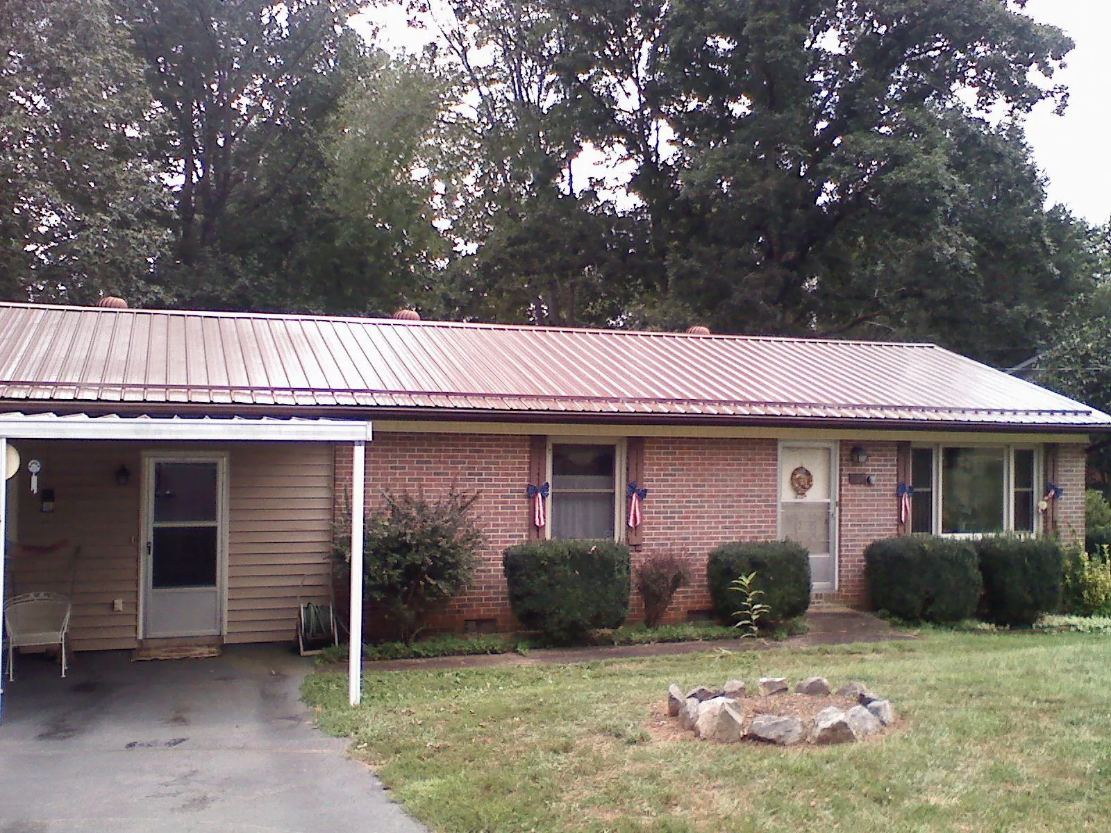 Bronze metal roof and carport on a brick ranch home — Roof Repair work by our crew in Brecksville